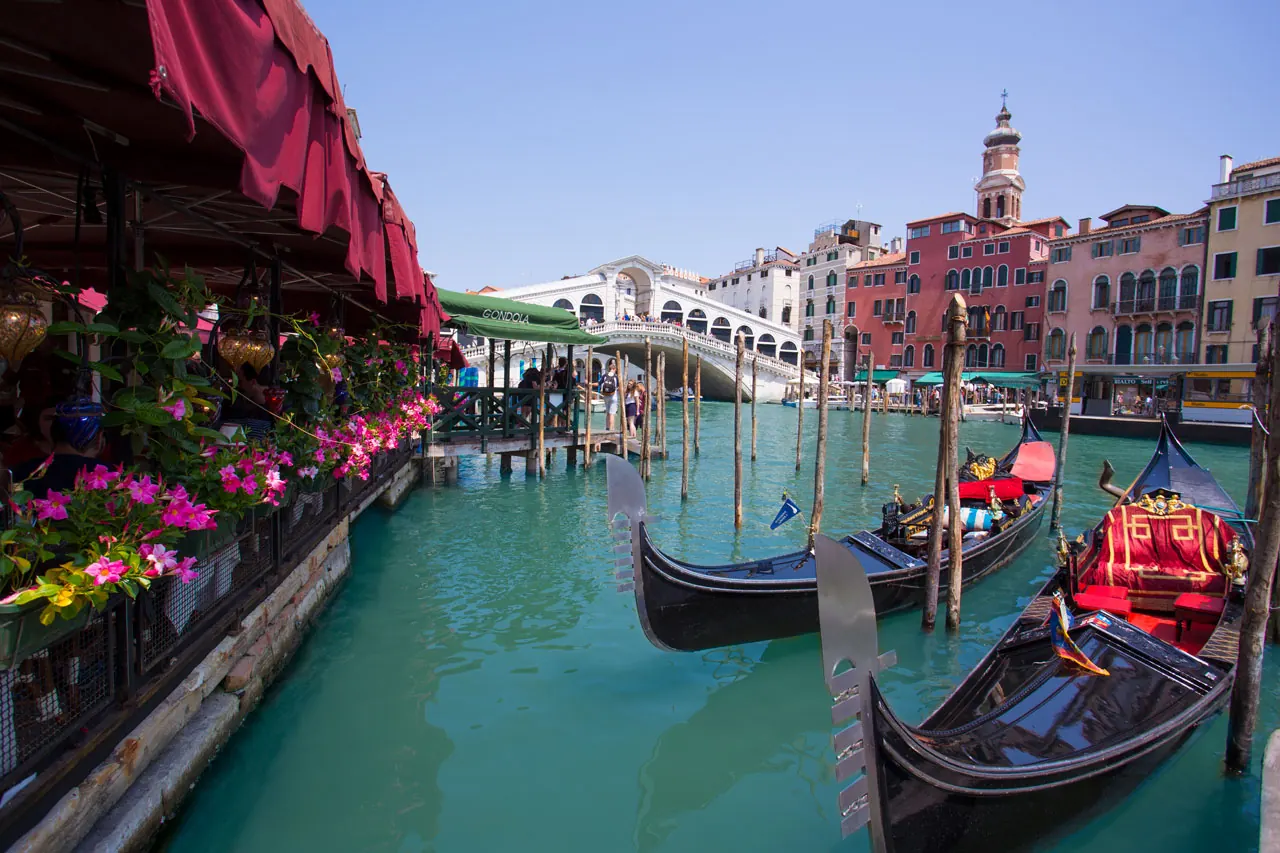 Rialto Bridge view with gondolas on the Grand Canal from the restaurant terrace